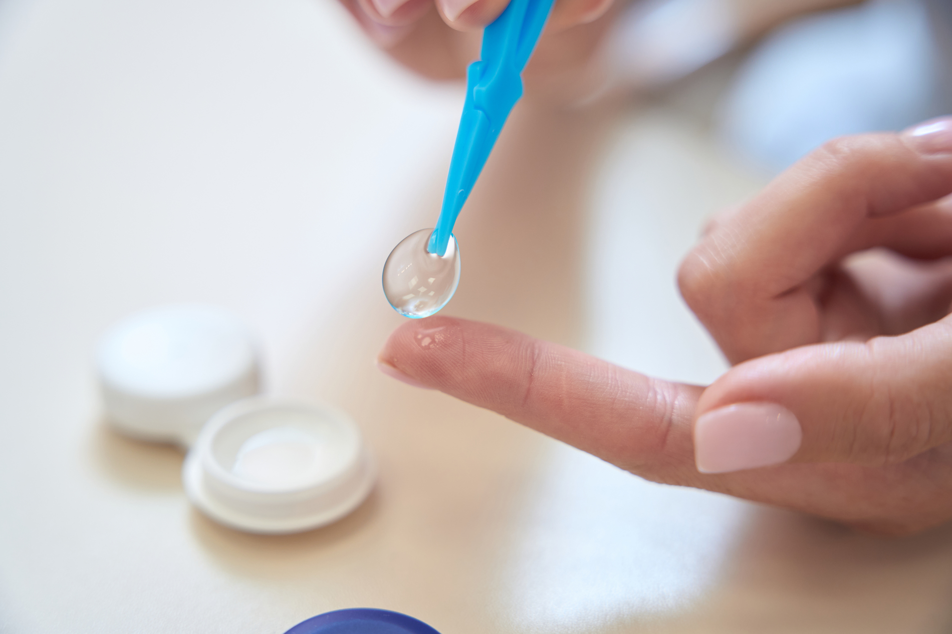 person holding a contact lens
